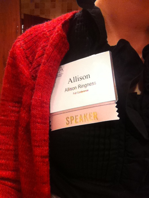 Conference badge with speaker ribbon.