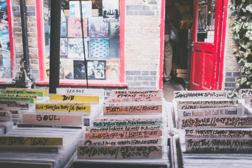 Handwritten dividers between records under a record store window
